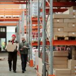 Croissance logistique : 2 personnes qui marchent dans un entrepôt